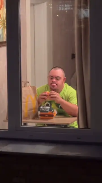 Green shirt, frozen stare